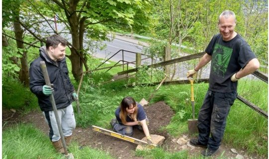 3 people working to lay steps