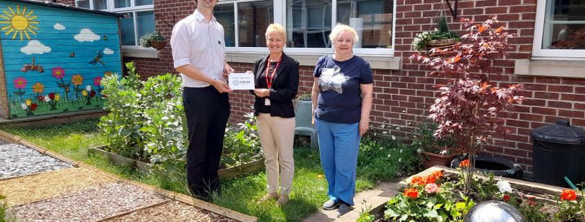 Cllr Ross-Shae and Cllr Gillian Thorne presenting a plaque to Fiona Meer, Co Headteacher at Low Ash Primary School