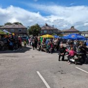 Festival goers sitting on benches