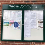 Wrose Community Notice Board. Glass fronted wall cabinet showing current notices