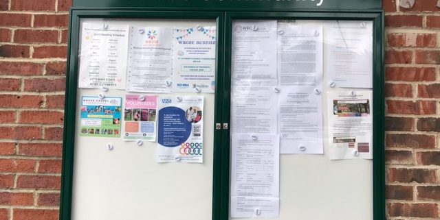 Wrose Community Notice Board. Glass fronted wall cabinet showing current notices